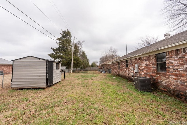 view of yard with a shed and central air condition unit