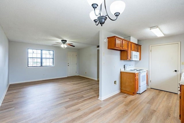 kitchen with white appliances, light hardwood / wood-style flooring, ceiling fan with notable chandelier, a textured ceiling, and decorative light fixtures