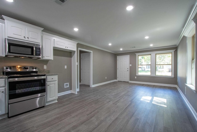 kitchen featuring wood-type flooring, ornamental molding, appliances with stainless steel finishes, light stone countertops, and white cabinets