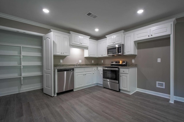 kitchen with white cabinetry, appliances with stainless steel finishes, and light stone counters