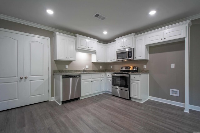 kitchen with white cabinetry, appliances with stainless steel finishes, dark hardwood / wood-style floors, and light stone counters