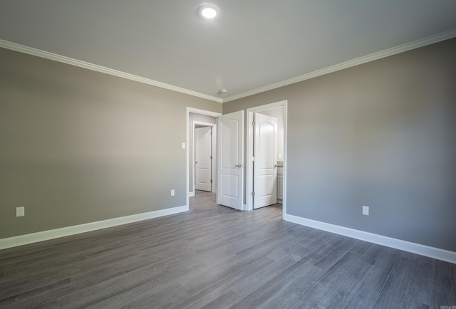 unfurnished bedroom featuring crown molding and dark wood-type flooring