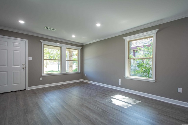 empty room with crown molding and dark wood-type flooring