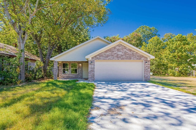 ranch-style home featuring a garage and a front yard