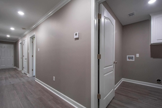 corridor with ornamental molding and dark wood-type flooring