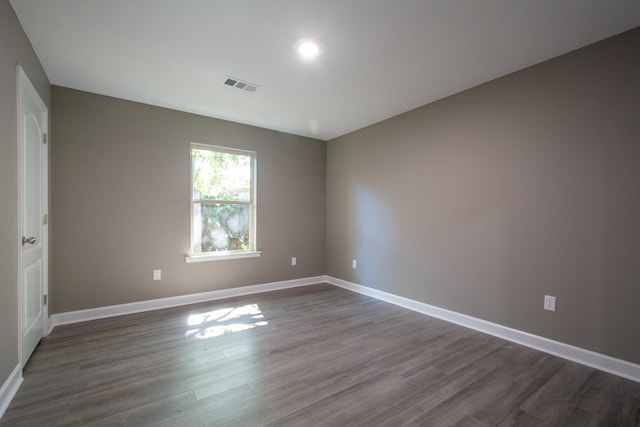 empty room with dark wood-type flooring