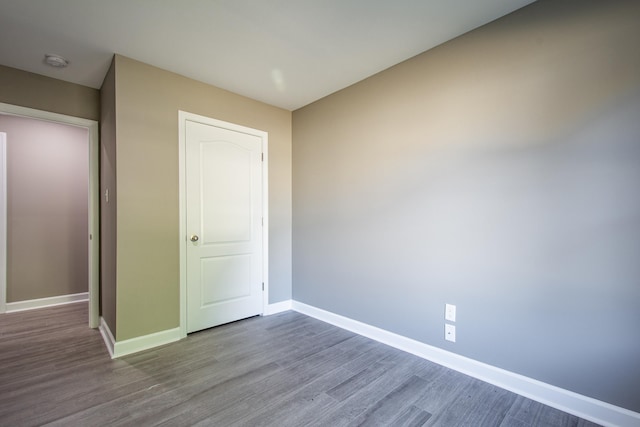 unfurnished bedroom with hardwood / wood-style flooring