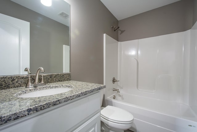 full bathroom with vanity, bathing tub / shower combination, and toilet