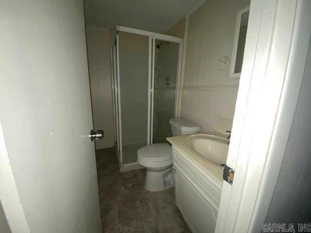 bathroom with vanity, toilet, and an enclosed shower