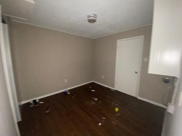 empty room with wood-type flooring