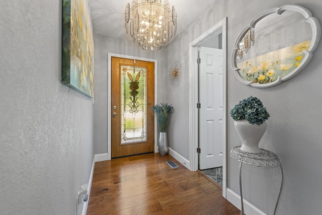 entryway featuring wood-type flooring and a notable chandelier