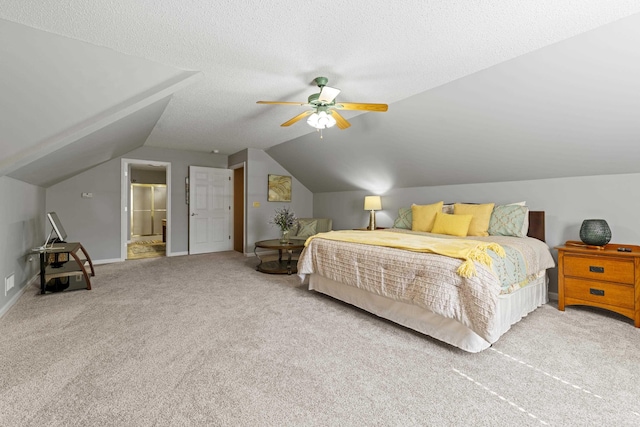 carpeted bedroom with vaulted ceiling, ceiling fan, and a textured ceiling