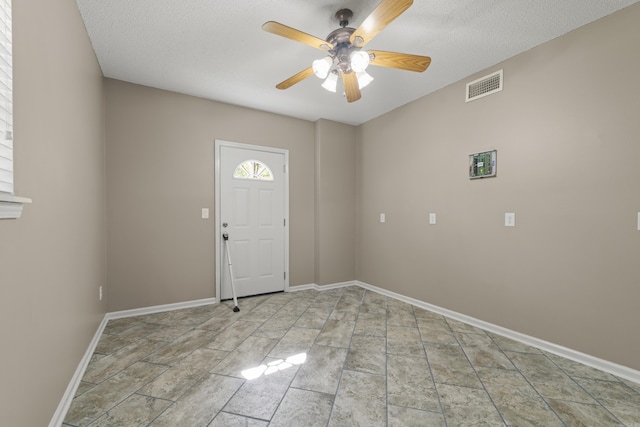 entrance foyer with a textured ceiling and ceiling fan