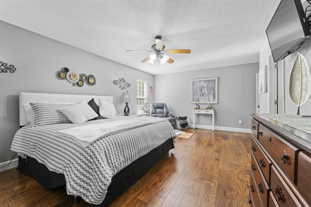 bedroom featuring ceiling fan, a textured ceiling, and dark hardwood / wood-style flooring