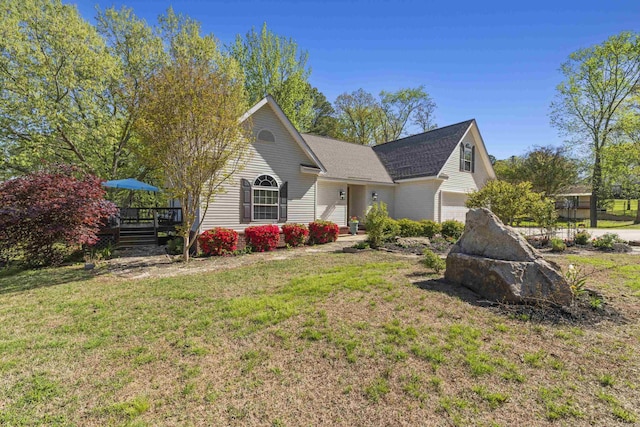 view of front of property featuring a garage and a front lawn