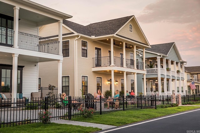 exterior space with fence and a shingled roof