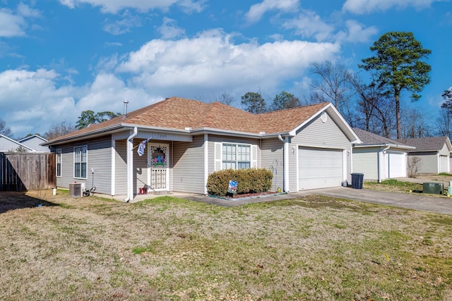 view of front of house with a garage, central AC, and a front yard