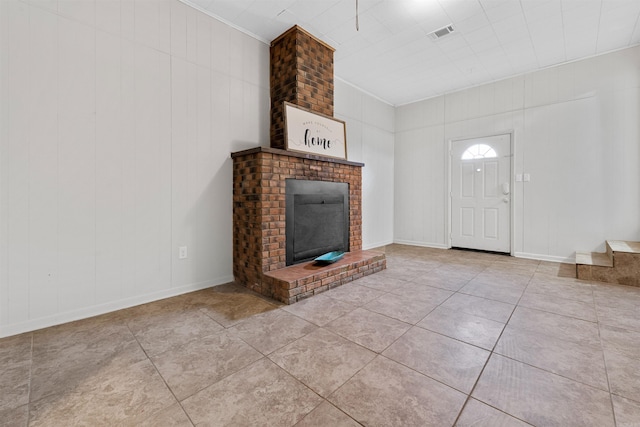 unfurnished living room featuring light tile patterned floors and a fireplace