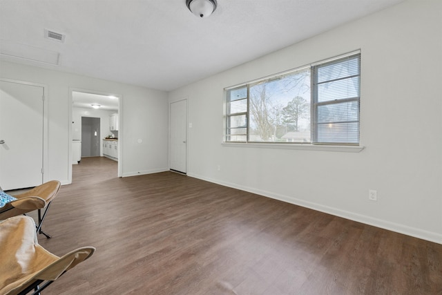 unfurnished living room with dark hardwood / wood-style flooring