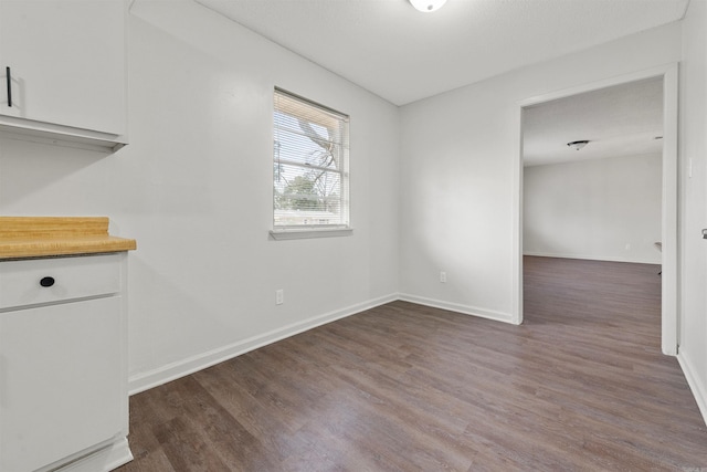 unfurnished dining area with dark hardwood / wood-style floors