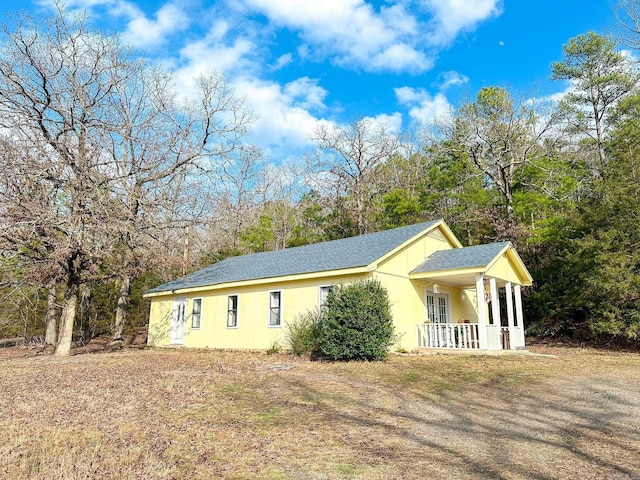 view of side of property with a porch