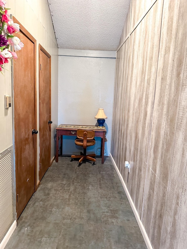 office with lofted ceiling and a textured ceiling