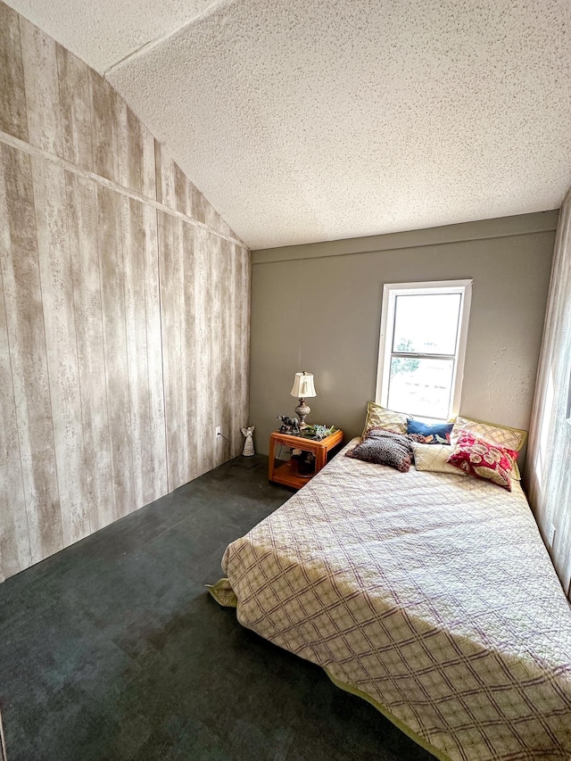 unfurnished bedroom with lofted ceiling, a textured ceiling, and carpet flooring