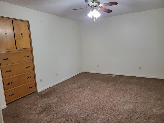 unfurnished room featuring ceiling fan and carpet floors