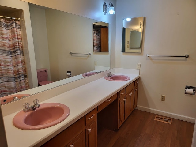 bathroom featuring hardwood / wood-style flooring, vanity, and toilet