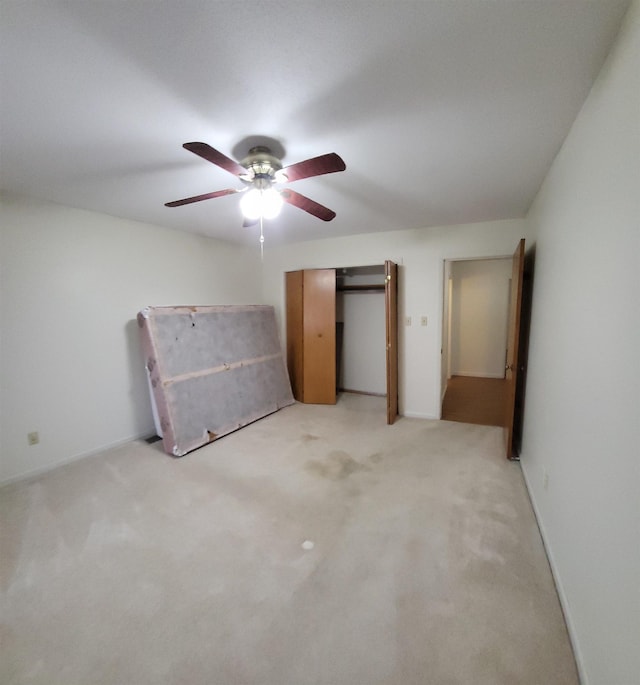 unfurnished bedroom featuring ceiling fan and light colored carpet