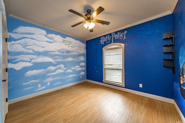 empty room featuring hardwood / wood-style flooring, ornamental molding, and ceiling fan