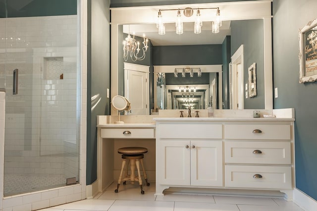 bathroom with tile patterned flooring, vanity, a notable chandelier, and a shower with shower door