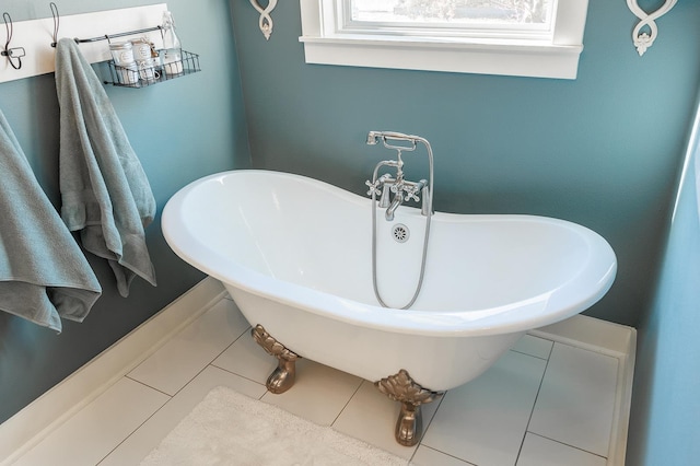 bathroom featuring a bath, tile patterned floors, and sink