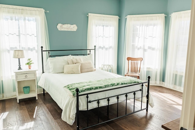 bedroom with dark hardwood / wood-style flooring