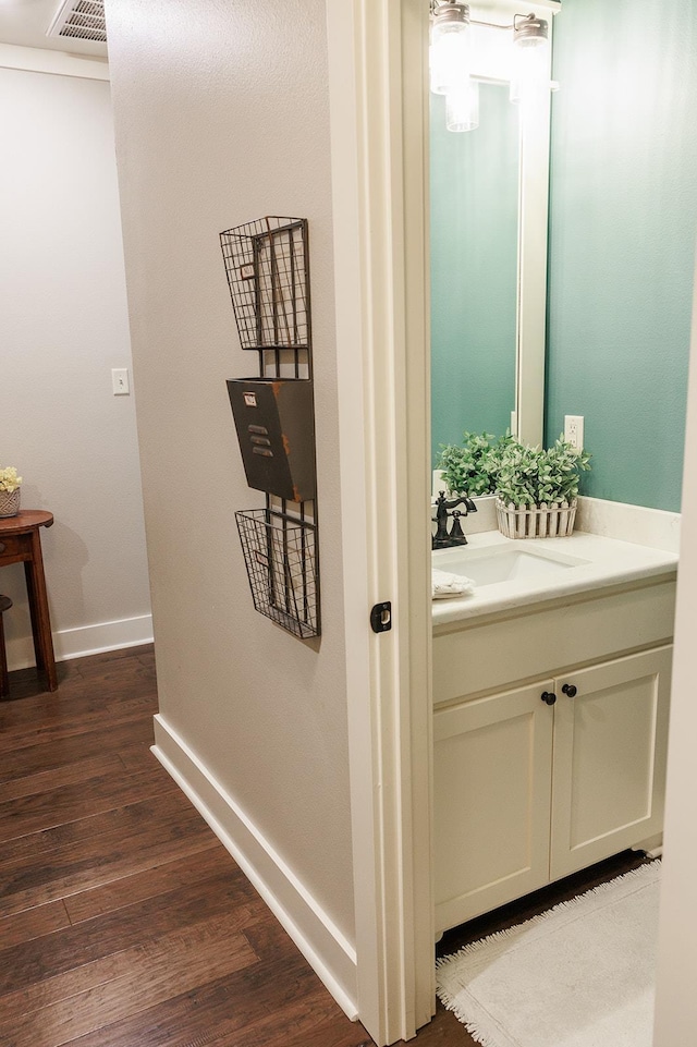 bathroom featuring hardwood / wood-style flooring and vanity