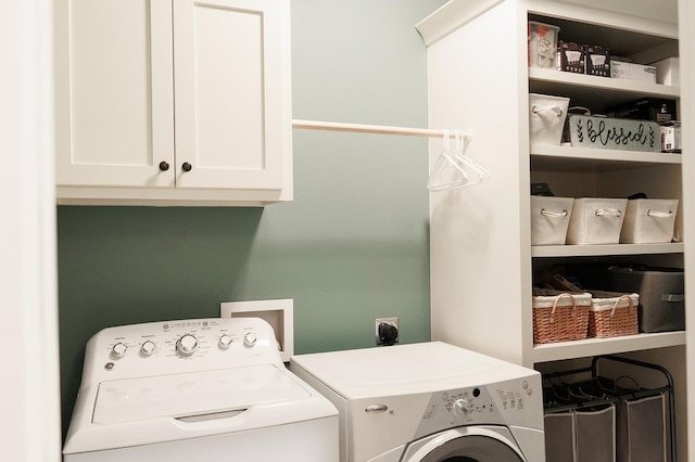 laundry area with cabinets and washing machine and dryer