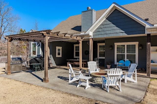 back of house featuring a patio, a pergola, and a fire pit