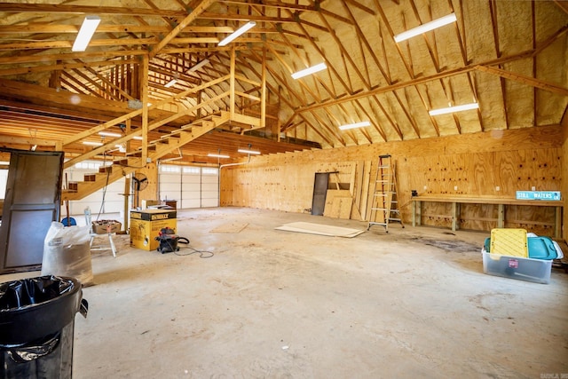 misc room featuring a garage and lofted ceiling