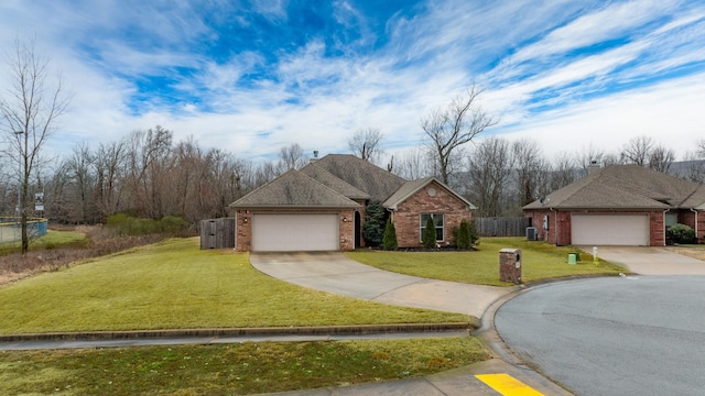 view of front of house with a garage and a front lawn