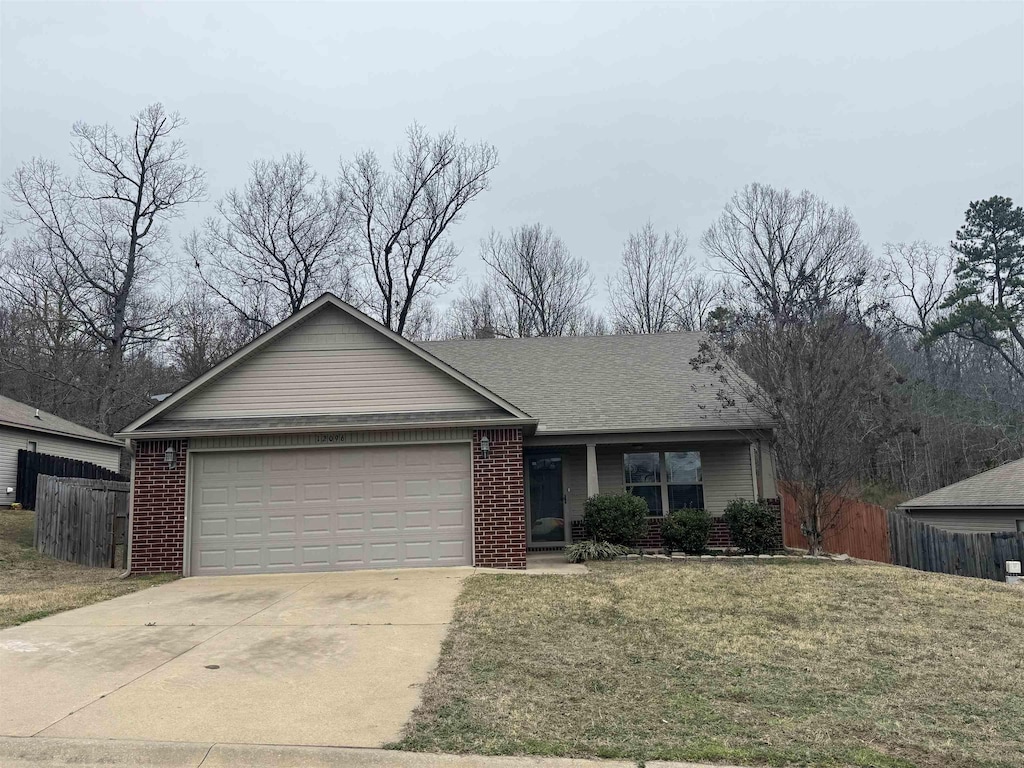 single story home featuring a garage and a front lawn