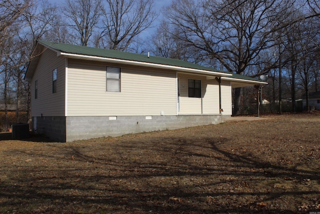 view of side of home with central AC