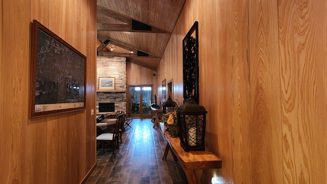 hallway with wood walls, high vaulted ceiling, wooden ceiling, dark hardwood / wood-style floors, and beamed ceiling