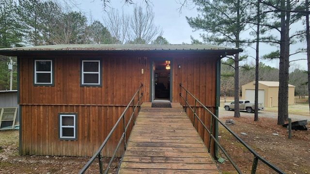 view of front of property featuring a storage unit