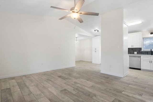 unfurnished living room featuring ceiling fan, vaulted ceiling, and light hardwood / wood-style flooring