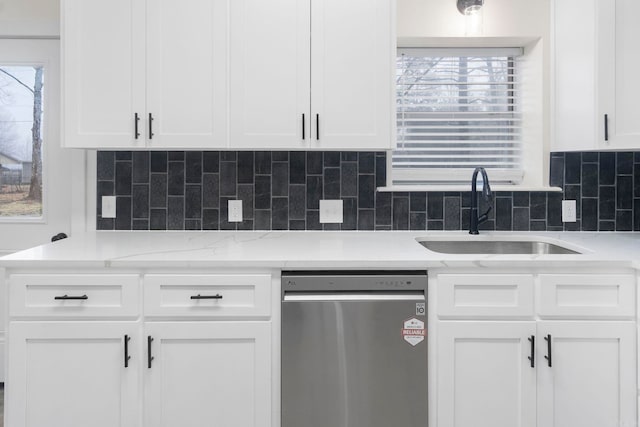 kitchen with white cabinetry, dishwasher, and sink