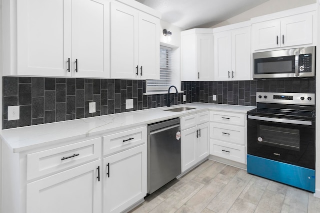 kitchen featuring white cabinetry, sink, and appliances with stainless steel finishes