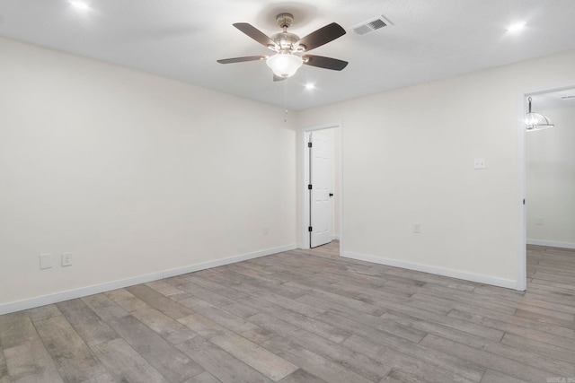 unfurnished room with ceiling fan and light hardwood / wood-style flooring