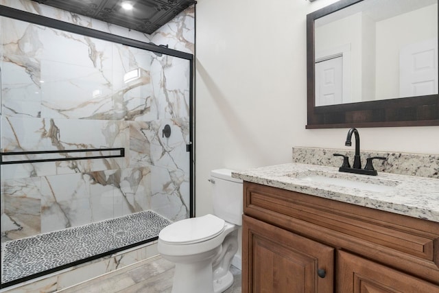 bathroom featuring vanity, toilet, and an enclosed shower