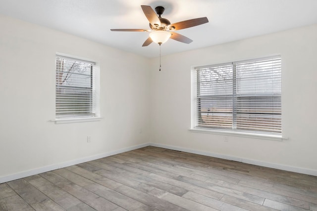 empty room with ceiling fan and light wood-type flooring