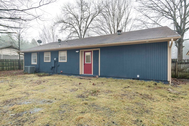 back of house featuring cooling unit and a yard